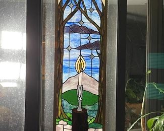 STAINED GLASS PANEL | leaded stained glass showing a candle burning before a colorful landscape; 38 x 13 in. 