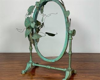 MIXED METAL MINIATURE VANITY MIRROR | painted green with metallic viney leaves surrounding an oval mirror; 13 x 10 x 6 in. 