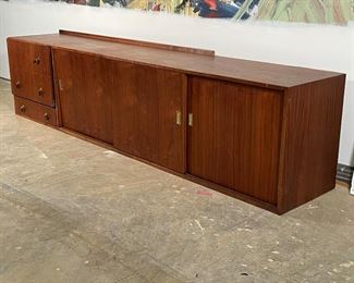 MID CENTURY WALNUT CABINET | wall mounting cabinet with sliders, bank of drawers; missing part of backsplash; needs work; h 23 x 96 x 18 in. 