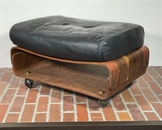 MID CENTURY BENT PLYWOOD OTTOMAN | rosewood veneer, one wheel loose and cushion hard - needs some work; h. 16 x 26 x 22 in. 
