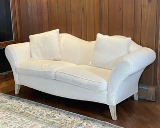 HIGHLAND HOUSE WHITE SETTEE | double camel back, two cushions, outset arms over whitewashed legs; h. 37 x 88 x 39 in.