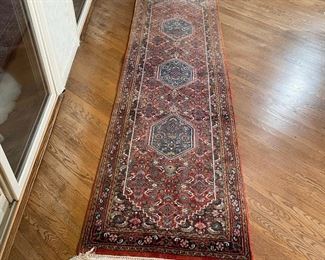 GEOMETRIC WOOL RUNNER | three blue medallions on a red ground; 10ft-2in. X 2ft-9in.