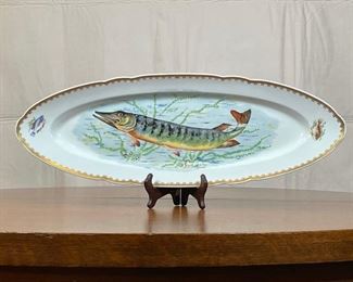 FRENCH PAINTED FISH PLATE | showing a fish swimming among sea plants, with two smaller fish painted on the ends; on verso "Hand Painted / Made in France"