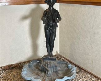 METAL & COMPOSITE FOUNTAIN | a painted white metal cherubic figure playing pipes mounted on a composite shell bowl with plumbing; h. 36 x 24 x 27 in.