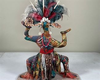 STITCHED MOUNTED DOLL | painted mask face, adorned with coral, porcupine quills, shells, wooden beads, and dressed in fabric trimmings; h. 20 in.