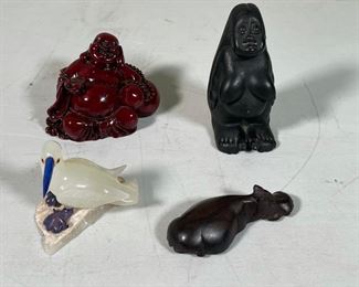 (4pc) DECORATIVE FIGURES | including a composition happy buddha, a glass bird, a carved wooden hippo, and a Hawaiian figurine carved from lava (h. 4 in.)