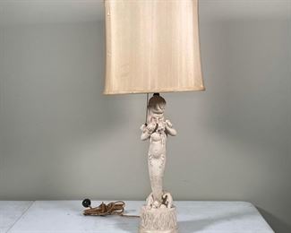 FIGURAL COMPOSITION LAMP | showing a mermaid child holding shells; h. 31 x dia. 12 in.