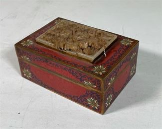 CARVED JADE & CHAMPLEVE ENAMEL BOX | the top set with an intricately carved jade plaque of a sinous dragon (broken, pieces mising), the box with red champleve enameling with blue scrolls and white flowers; 2-1/2 x 5 x 3-1/2 in.