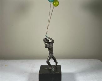 BRONZE & BLOWN GLASS FIGURE | depicting a young boy leading three blown glass balloons, indistinctly signed; h. 23 in.