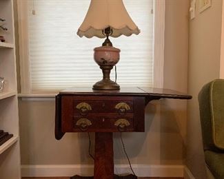 Lamp- Victorian oil lamp converted to electric.                         Table- American pedestal table, mahogany & tulip poplar.  26.5" H  x 17" SQ.  1835-1845 