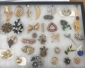 Large quantities of costume jewelry.  This is a sample of the pins