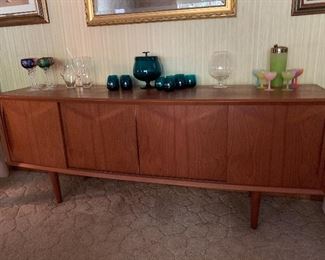 BID ITEM: Danish Modern Sideboard Credenza with felt lined silver drawers, sliding doors, adjustable shelves Measures 6' and 7" in length and 31" height