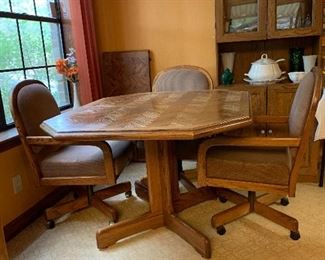 Octagonal table with leaf and four swivel fully reclining chairs on casters, closed table measure 4' by 42" leaf adds 18" 