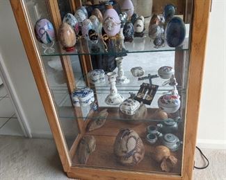 Egg collection includes paperweights, music box, jasper, cloisonnee and porcelain. Porcelain trinket boxes. Pottery pieces.