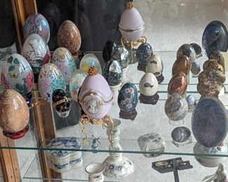 Egg collection includes paperweights, music box, jasper, cloisonnee and porcelain.