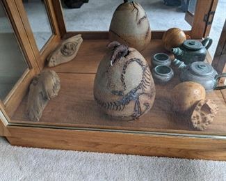 Surrealist dinosaur hatching from egg, box elder burl, tea pot and cup.