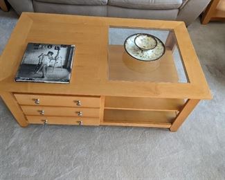 Contemporary styled coffee table with half glass top and storage