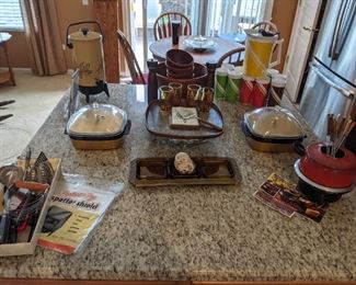 MCM kitchen and entertaining items, fondue set, utensils, covered cold/hot servers, Libbey wheat juice glasses, wood salad bowls, Thermo Serv pitcher, green, red and brown tumblers