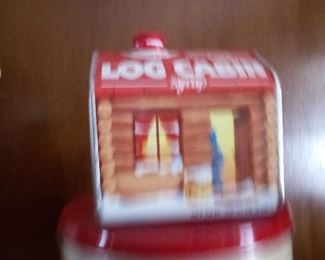 97. LOG CABIN TIN $5