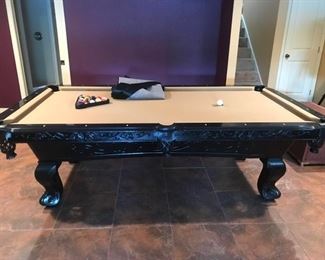 ornate pool table with accessories 