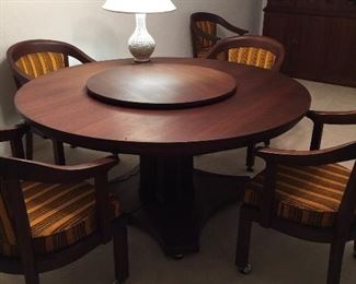 Teakwood round table on rollers. And lazy Susan with 6 chairs on rollers