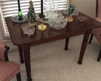 Old antique farm kitchen table used as a sofa table or desk. 