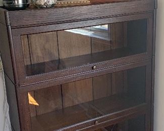 Antique glass front bookcase. Likely built in at some point. The back legs are not there, see additional photo. 