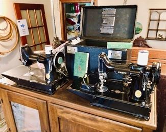 TWO Singer Featherweight sewing machines!  Model 221-1.  The unit on the right comes complete with case, manual, lubricant, foot pedal and other accessories.  The left unit comes with only its foot pedal.