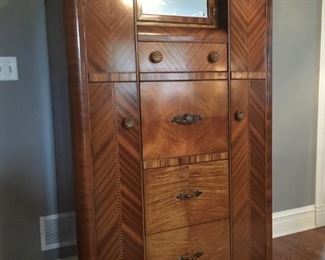 Wonderful waterfall / Art Deco armoire/secretary.  71" high, 40" wide, 21" deep. Features a drop-leaf desk, 2 clothing cubbies, and hidden compartment behind the mirror. 