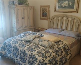 Cream with turquoise accents, big dresser with mirror is in other room.