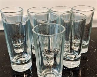 $8 each - Eight shot glasses with coat of arms emblem; 3 in. H