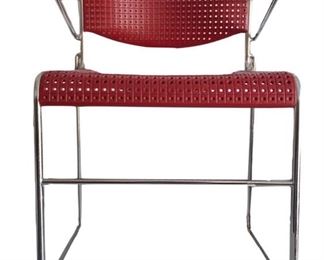 One of four Emeco chairs, designed by Richard Ogg; two with oxblood perforated vinyl, two with graphite
