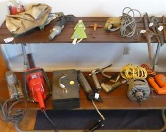 Motors, grinders, and various other tools.  Sitting on one half of a fold up picnic table
