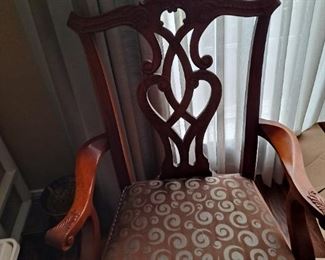 One of the chairs that goes with the dining room table.