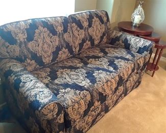 Love seat size hide-a-bed. Black with gold tapestry design. Like new. Must see.