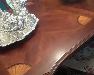 Note inlay fan shape design on both end of the dining table. One center leaf with custom desiged padded protector top. All like brand new.