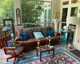 Leather sofa, corved coffee table, leaded glass windows, Tiffany-style lamp