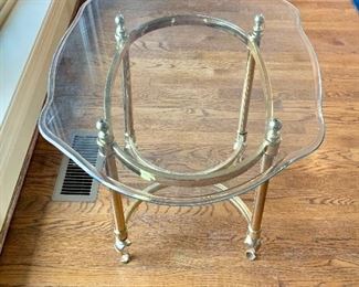 $75 - Glass top table with brass legs -  22"H; 29"W; 23"D