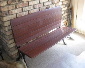 Wood slat bench having iron legs