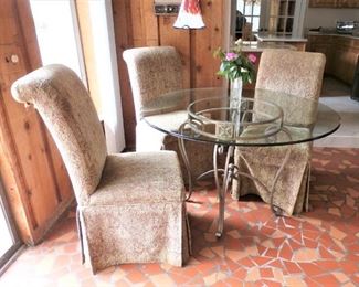 GLASS ROUND DINETTE TABLE AND 4 UPHOLSTERED PARSONS CHAIRS - WILL DIVIDE