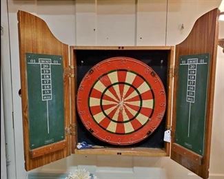 Vintage dart board in cabinet