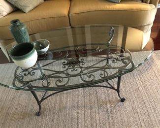 $95 / Oval glass top table with iron base. 48" wide x 28" deep x 20" tall.  TO PURCHASE, TEXT 404-771-6060.