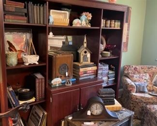 BOOKCASES AND ENTERTAINMENT CENTER.  1800'S TRUNK.  LOTS OF CLOCKS.