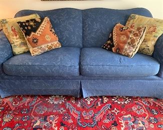 Nicely upholstered blue sofa in pristine condition