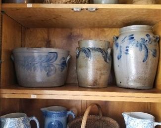 Cobalt decorated salt glaze stoneware including milk pan (middle shelf, far left)