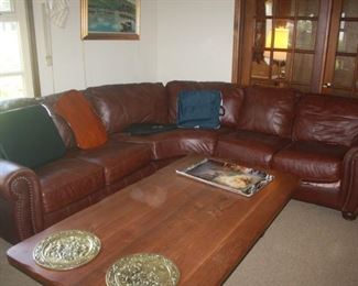 LEATHER SECTIONAL . WITH HUGE WOOD COFFEE TABLE