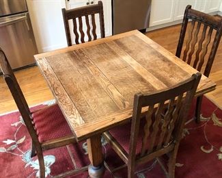 Farmhouse Pub Table featuring both sides tucked underneath the table top. Just lift the table top up and slide out the leaves for a larger table or a place setting for six. 