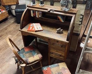 Antique child’s size oak roll top desk.  It boasts 2 working drawers and mail slots.