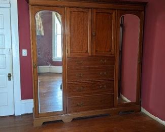 Double door wardrobe with drawers in middle.