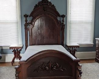 Victorian hand-carved mahogany full-sized bed with bedding, part of three piece suite. 